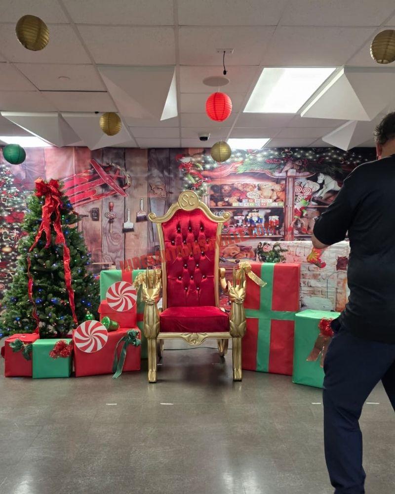 Santa photos in Nashville: gold chair among gift boxes and a lit tree ready for a photo session.